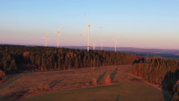 Aerial View, Wind Park and Turbines in Countryside Landscape on Sunset Sunlight. Alternative Energy