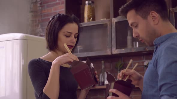 Family Eat Takeaway Food in Kitchen at Home