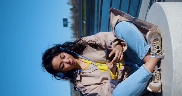 Vertical Video of an Asian Woman Meditates on the Embankment