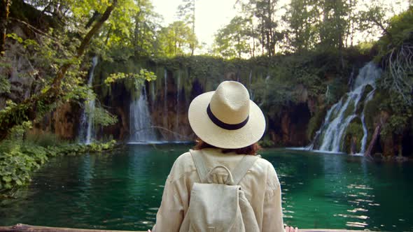 Young woman looking at waterfalls in the park