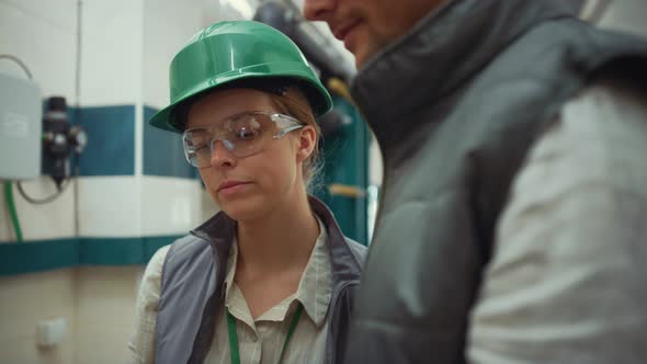 Woman Supervisor Talking Colleague at Modern Manufacture Facility Close Up