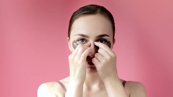 Head shot portrait close up smiling young woman with under eye moisturizing patches mask 