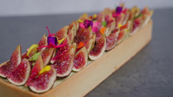 Biscuit Decorated with Fig Slices Standing on Grey Surface