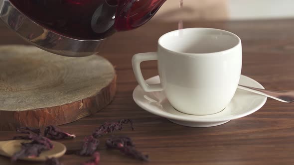 Hot Red Tea Pouring Into A Mug Close Up. Step Four. The Process Of Pouring Red Tea Into A White Cup