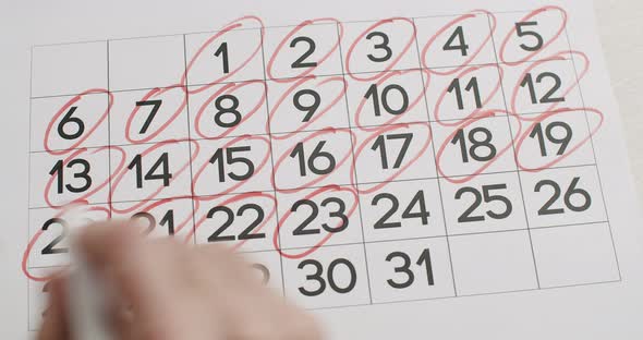 Man's hand Write down the 21,22,23,24,25,26,27,28,29,30,31 th day on calendar.