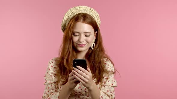 Attractive Woman Receives Happy Notification on Mobile Phone. Girl Is Beside Herself with Surprise