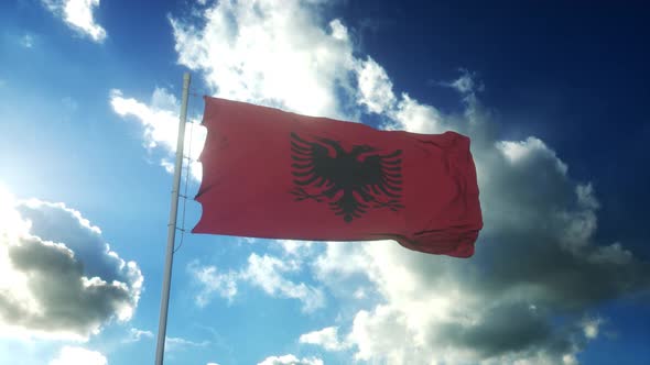 Flag of Albania Waving at Wind Against Beautiful Blue Sky