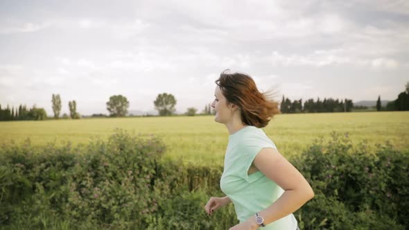 Young Caucasian Girl Woman Enjoying Life And Running Jogging In Spanish Countryside Road Through