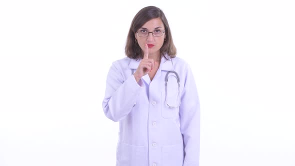 Happy Beautiful Woman Doctor with Finger on Lips