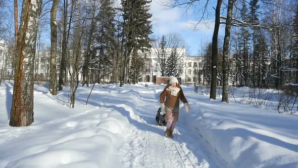 Red-Haired Child, Little Girl Running With Sledge on Winter Park Kid Teenage Walking