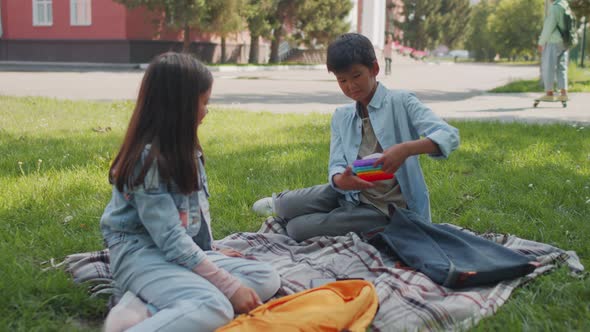 Kids Playing with Sensory Fidget Toys in Schoolyard