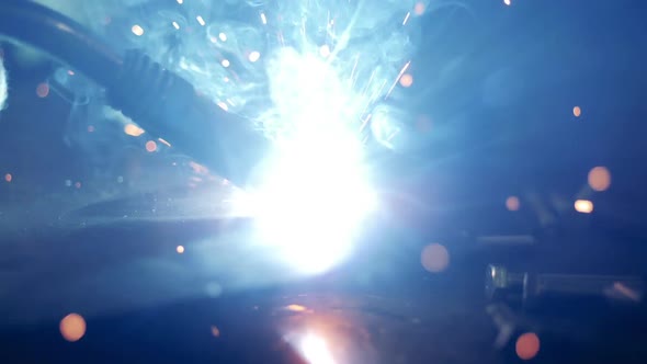One Man Uses Welding Machine at a Factory