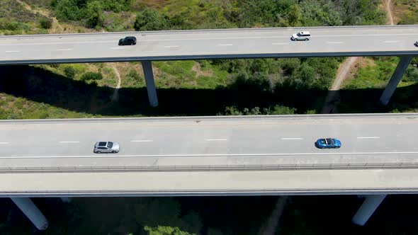 Aerial View of Road Highway Bridge, Viaduct Supports in the Valley Among the Green Hills.