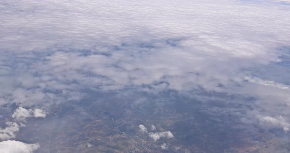 The View From the Plane of Fluffy Clouds in Desert Mountains From an Airplane New Mexico USA