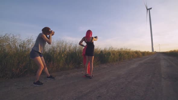 Woman Fashion Photographer Photographing on Camera a Stylish Young Woman Model with Red Hair and