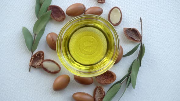 Argan Oil and Seeds on a White Background