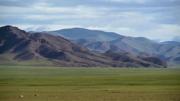 Asian Yurts in Green Plain Beside The Treeless Hill