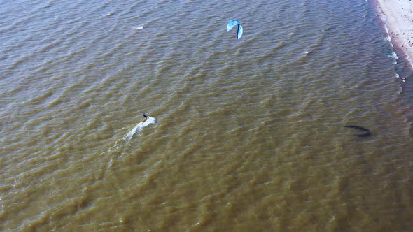 people kite surfing ride on the waves in the Baltic Sea