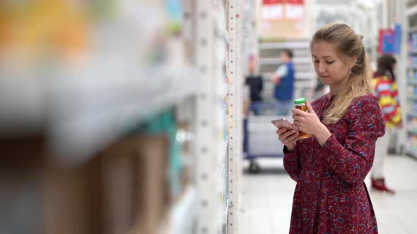 Attractive Young Woman Choosing Products in Supermarket Marketplace