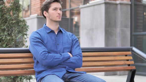 Young Man Sitting Outdoor on Bench