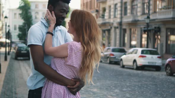 Young Couple in Love Standing and Tenderly Cuddling on Streets of European Cities