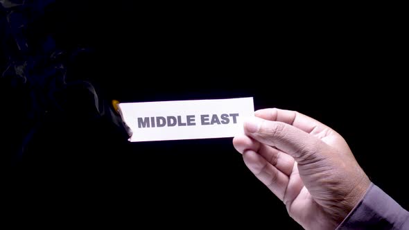 Hand Holds Paper Burning Middle East