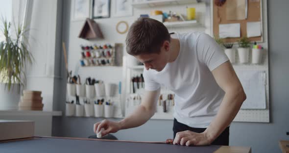 Leather Worker Oiling a Leather Belt During Manufacturing Process