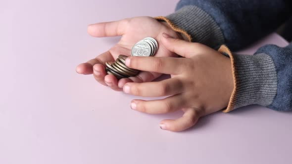 Slow Motion of Child Girl Counting Coins on Hand