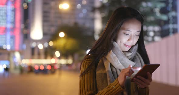 Asian woman use of smart phone at night