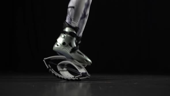 Close-up Motion of Trainer's Legs Performing in Kangoo Jumps Shoes.