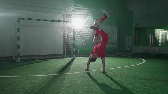 Slow Motion Professional Football Player Performs Series of Tricks with a Soccer Ball Balances the