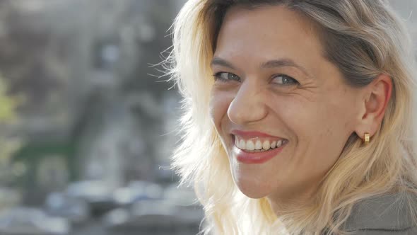 Lovely Mature Woman Smiling To the Camera Over Her Shoulder