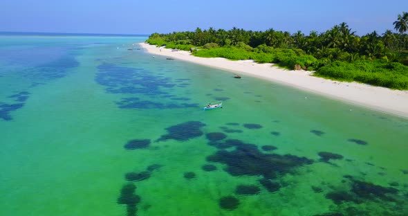 Tropical overhead copy space shot of a white sandy paradise beach and aqua blue water background in 