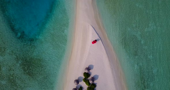 Luxury overhead island view of a white sand paradise beach and turquoise sea background in hi res 4K