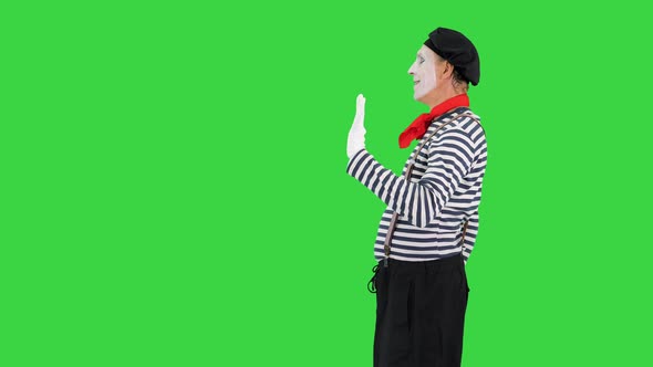 Mime Playing a Pantomime Performance Walking and Opening Imaginary Door on a Green Screen Chroma Key