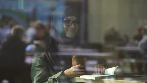 Young Arabic Female Student Reading Book in Cafe, Preparing for Test, Literature