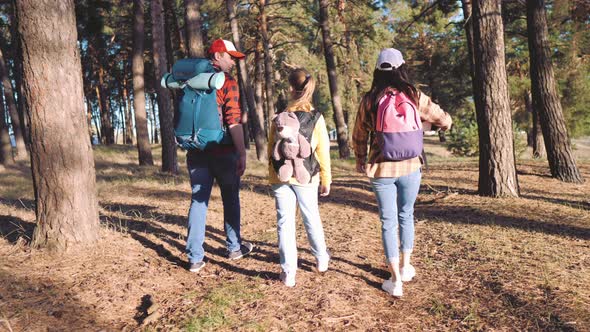 Happy Family Hiking Through a Forest