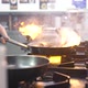 Worker Closes Burning Mussels and Scallops with Frying Pan - VideoHive Item for Sale
