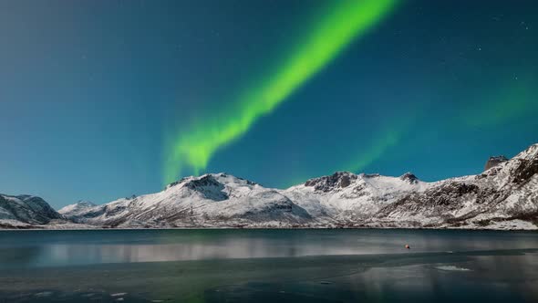 Aurora over the frozen lake in Lofoten, Norway.the Earth with green roof.