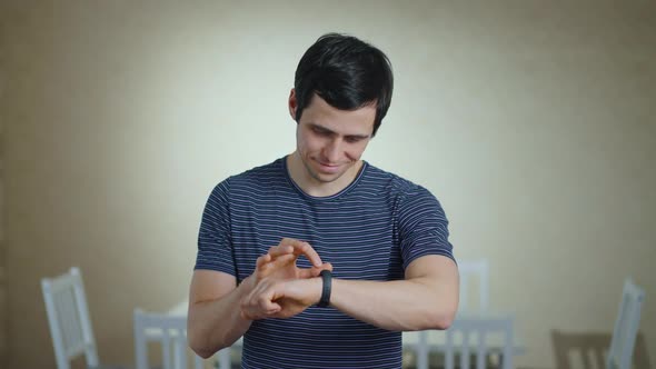 Smiling Man Using His Smart Watch