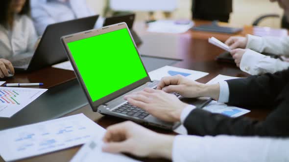 Businessman Working on Laptop With Green Screen at Business Meeting, Conference