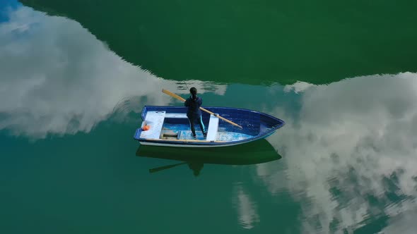 Woman on the Boat Catches a Fish on Spinning in Norway