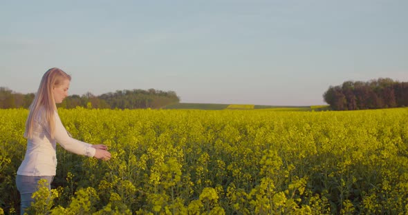 Young Farmer Using Digital Tablet at Oilseed Rape Field