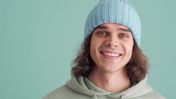 Cheerful man in blue hat looking at the camera