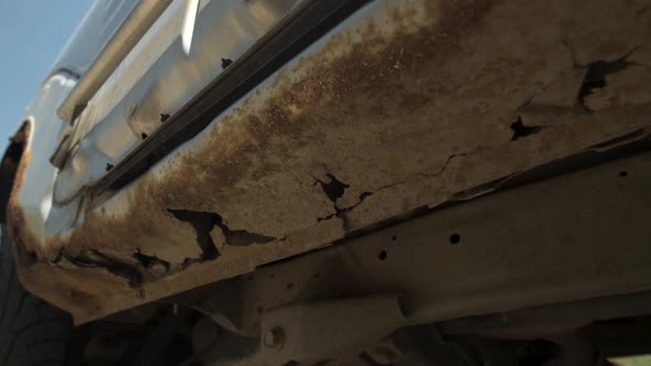 Deep Rust on the Body of a Gray Old Car