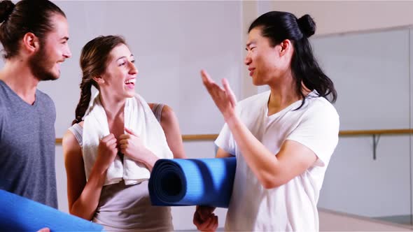 Group of fitness team interacting in fitness studio