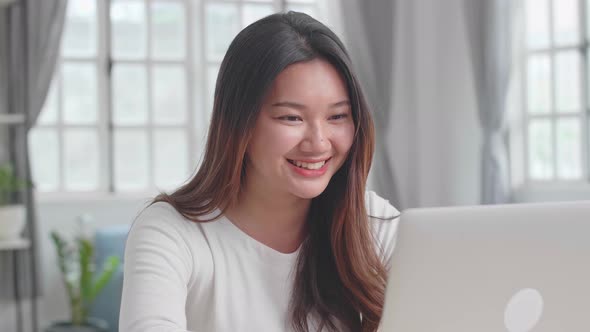 Asian Girl Use Laptop Computer And Smile