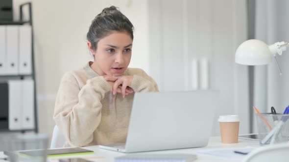 Indian Woman Thinking and Working on Laptop 