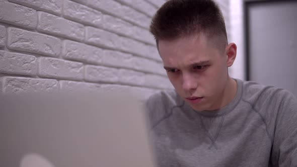 Young Shocked Man Using Laptop Sad Man Read Bad News Student or Freelancer Man