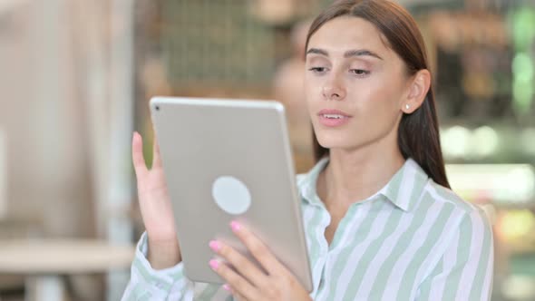 Young Latin Woman Using Digital Tablet